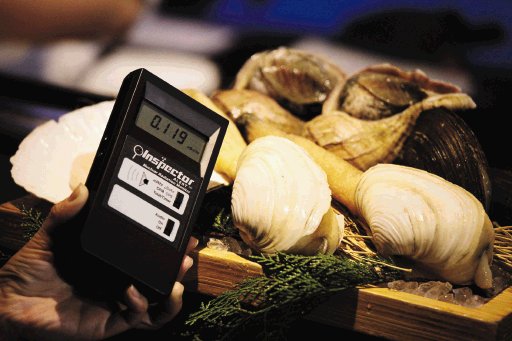 Un camarero comprueba los niveles de radiaci&#x00F3;n de unos moluscos de la zona de Kyushu. EFE.
