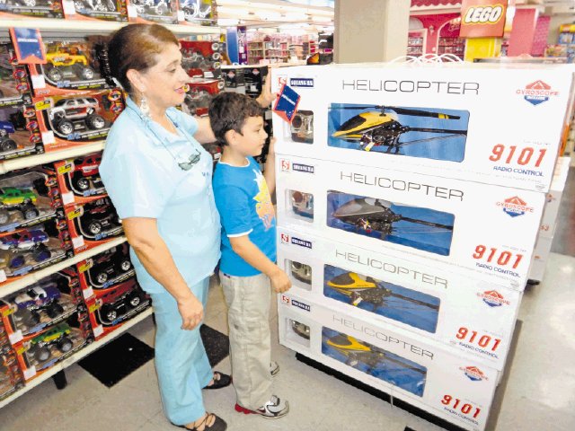  Temporada navideña seduce a ticos a comprar por anticipado. Alessandro Navarro y su abuela Ana, observan el helicóptero que quiere en Navidad.Herlen Gutiérrez.